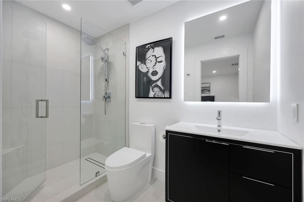 10002 Vanderbilt Drive Naples, FL 34108 - Photo 17 of 42 Crisp Black and white bathroom.