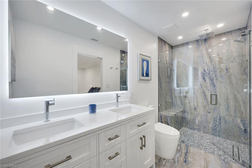 10002 Vanderbilt Drive Naples, FL 34108 - Photo 23 of 42 Stunning blue and earth tone porcelain tile in shower