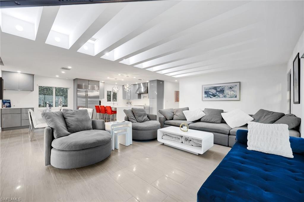 10002 Vanderbilt Drive Naples, FL 34108 - Photo 9 of 42 Open living room with grey tones and a splash of blue!