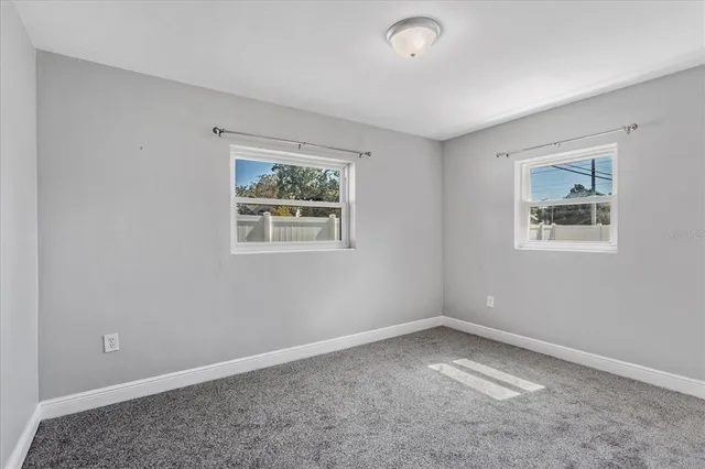 a bathroom with a granite countertop toilet a sink and mirror