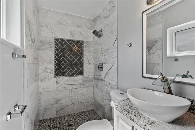 a white house that has tree in front of it