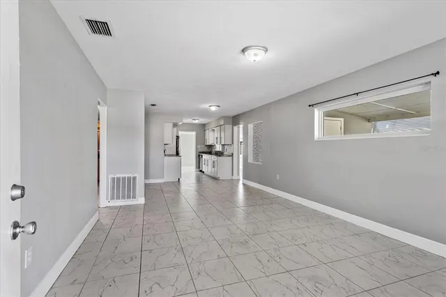 a view of a kitchen with a refrigerator and a stove top oven