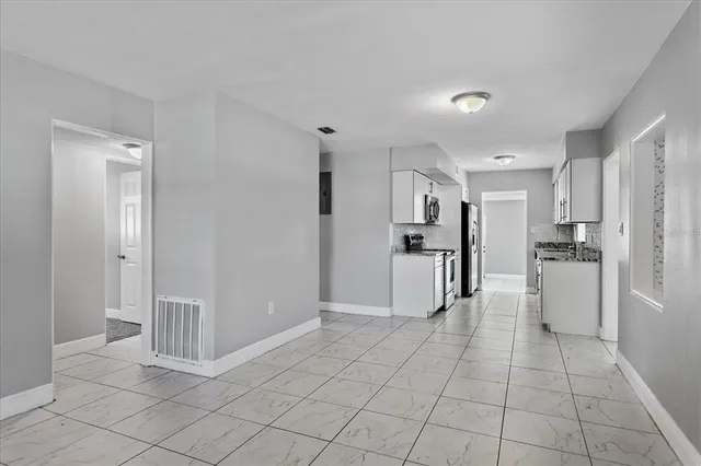 an empty room with windows and closet