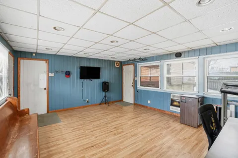 a living room with furniture a table and large windows