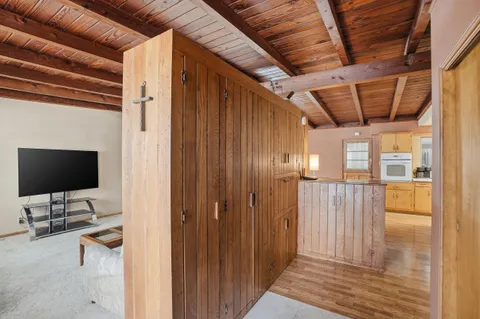 a view of a livingroom with wooden floor and flat screen tv