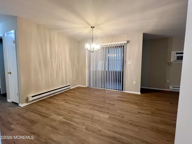 a view of a room with wooden floor and entryway