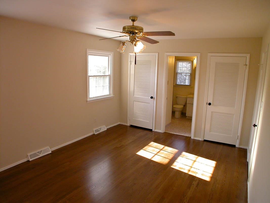 524 Harvard Street Raleigh, NC 27609 - Photo 14 of 25 Master Bedroom with his and her closets on both sides looking into the full bath.