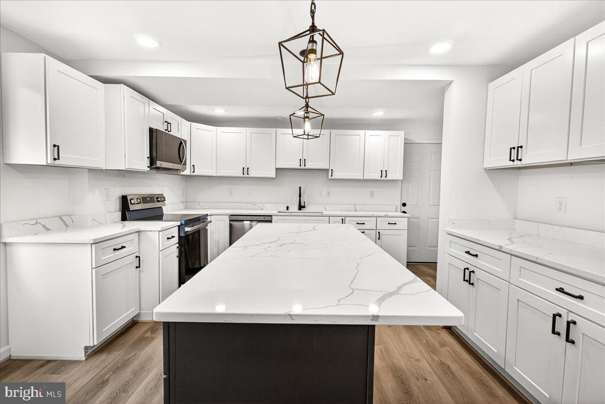 629 Wilson Place Frederick, MD 21702 - Photo 16 of 39 a kitchen with stainless steel appliances sink cabinets and refrigerator