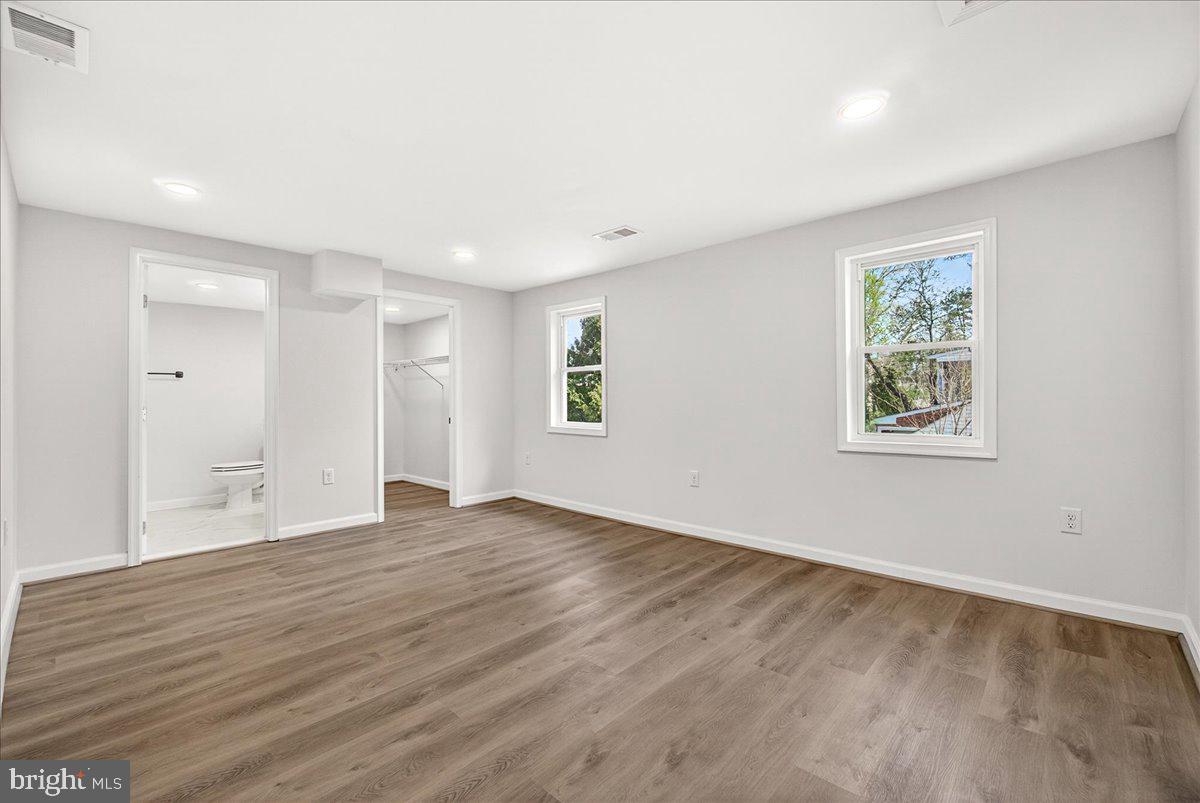 629 Wilson Place Frederick, MD 21702 - Photo 24 of 39 a view of an empty room with wooden floor and a window