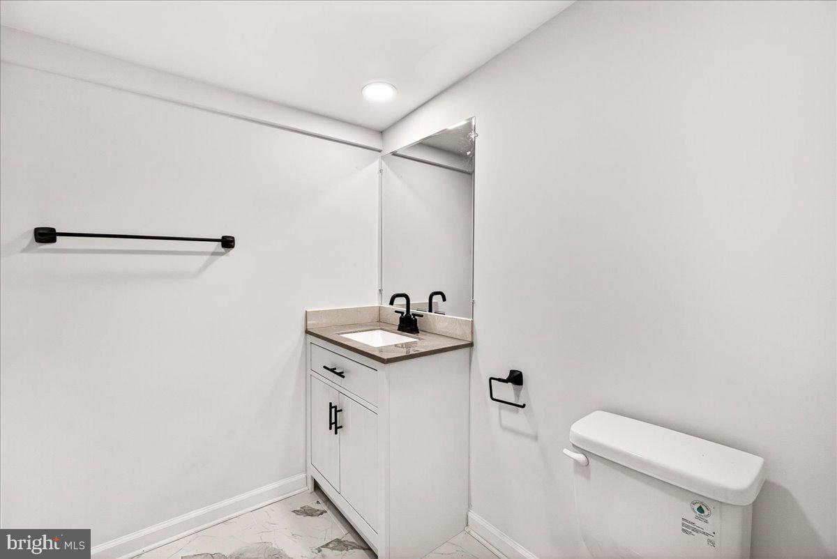 629 Wilson Place Frederick, MD 21702 - Photo 25 of 39 a bathroom with a sink a toilet and mirror