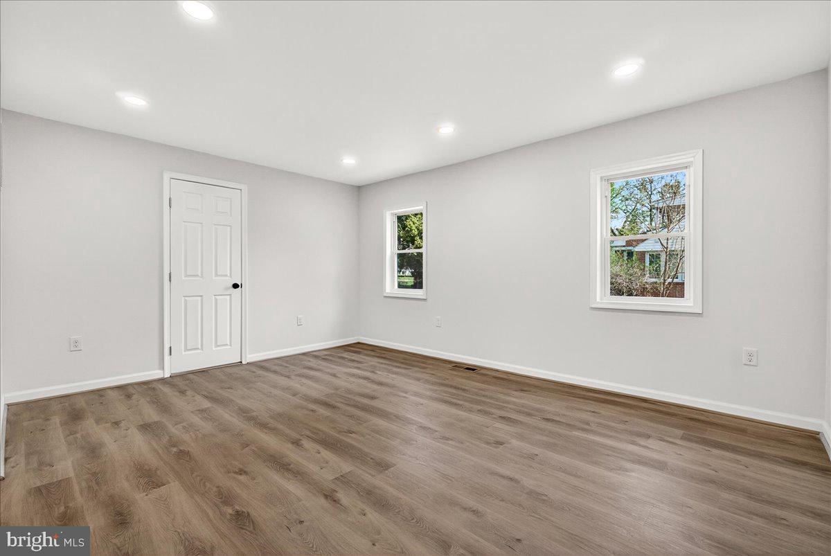 629 Wilson Place Frederick, MD 21702 - Photo 28 of 39 an empty room with wooden floor and windows