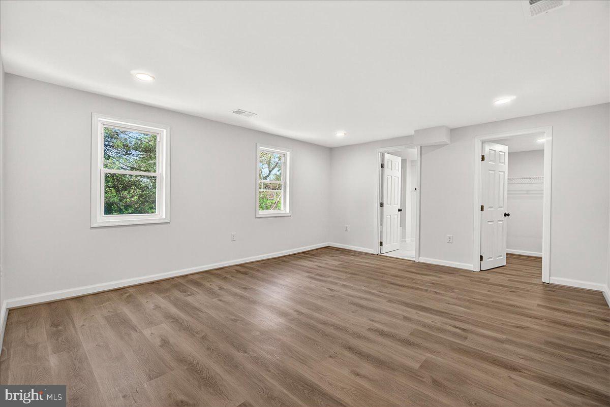 629 Wilson Place Frederick, MD 21702 - Photo 30 of 39 a view of an empty room with wooden floor and a window