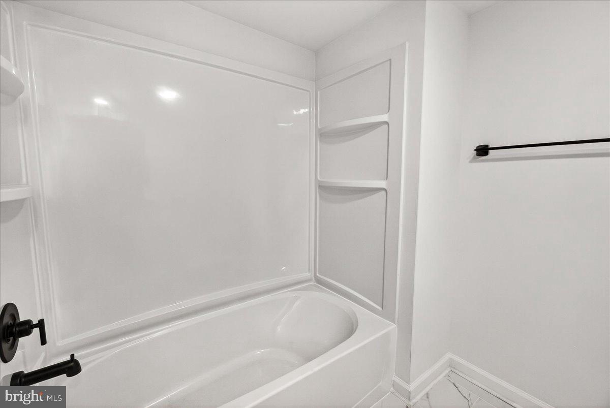 629 Wilson Place Frederick, MD 21702 - Photo 31 of 39 a bathroom with a bathtub and a shower