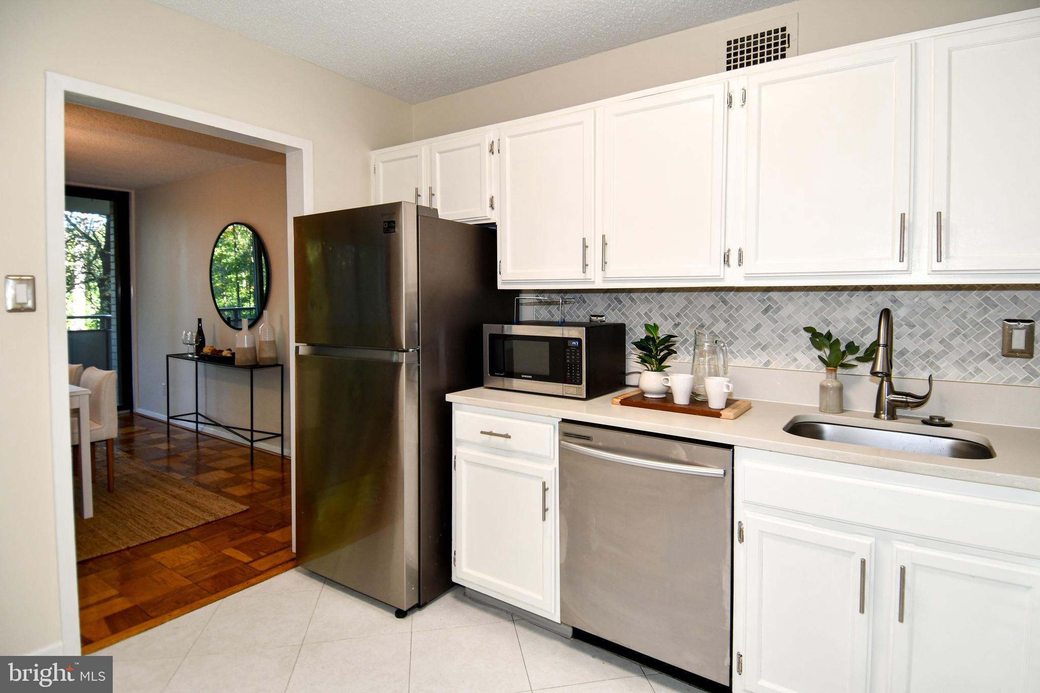 5225 Pooks Hill Road, Unit 222N Bethesda, MD 20814 - Photo 15 of 45 a kitchen with a refrigerator sink and cabinets