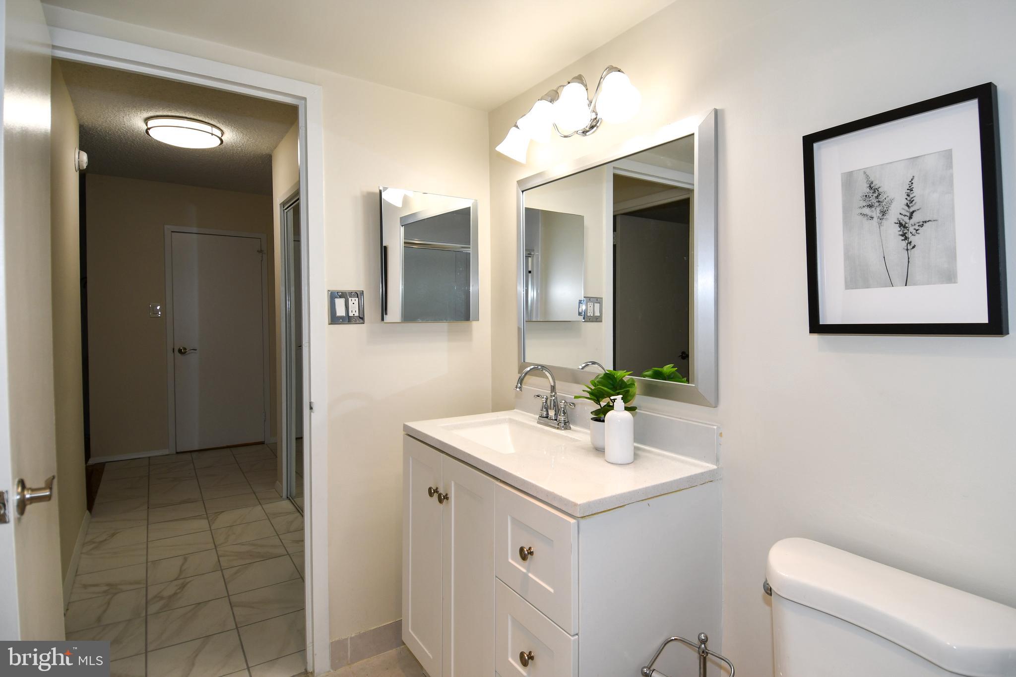 5225 Pooks Hill Road, Unit 222N Bethesda, MD 20814 - Photo 20 of 45 a bathroom with a toilet sink and mirror