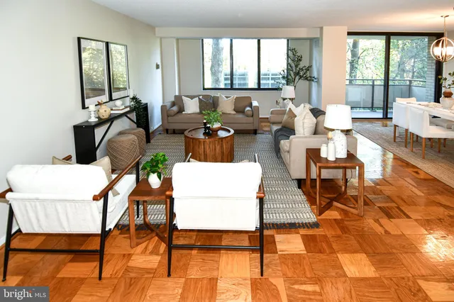 a view of a dining room with furniture and a chandelier