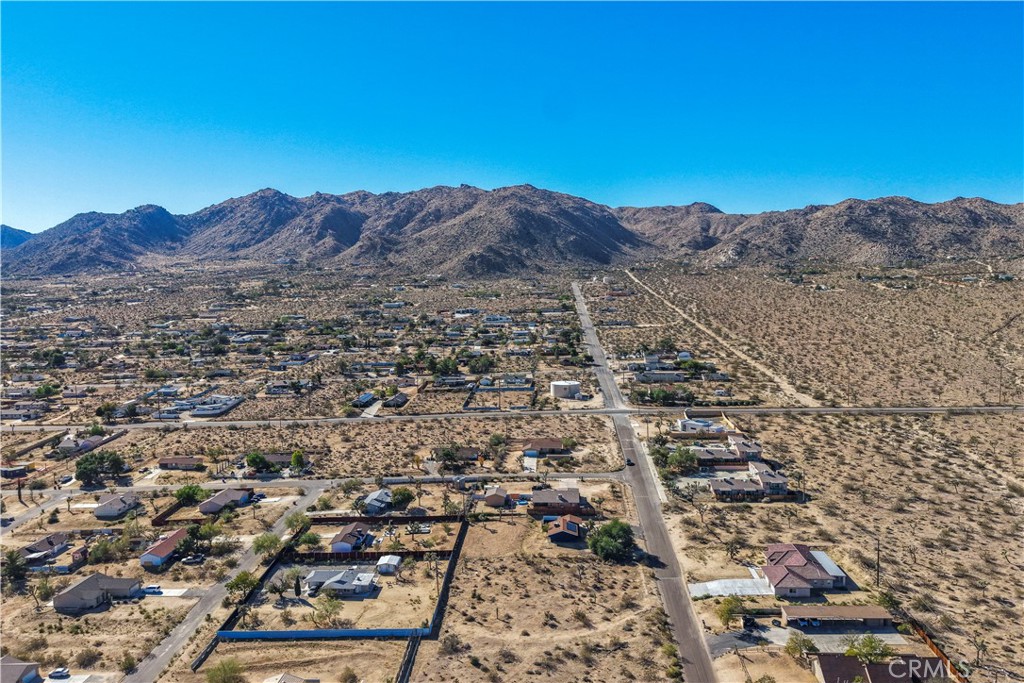 7201 Olympic Road Joshua Tree, CA 92252 - Photo 3 of 12 an aerial view of residential house and sandy dunes