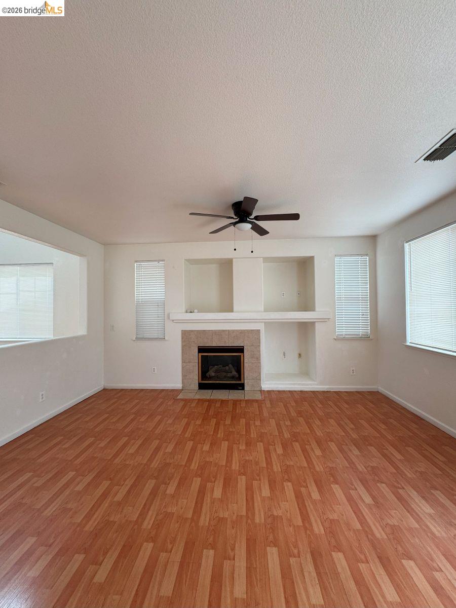 645 Rockspray Circle Pittsburg, CA 94565 - Photo 16 of 31 a view of empty room with wooden floor and fireplace