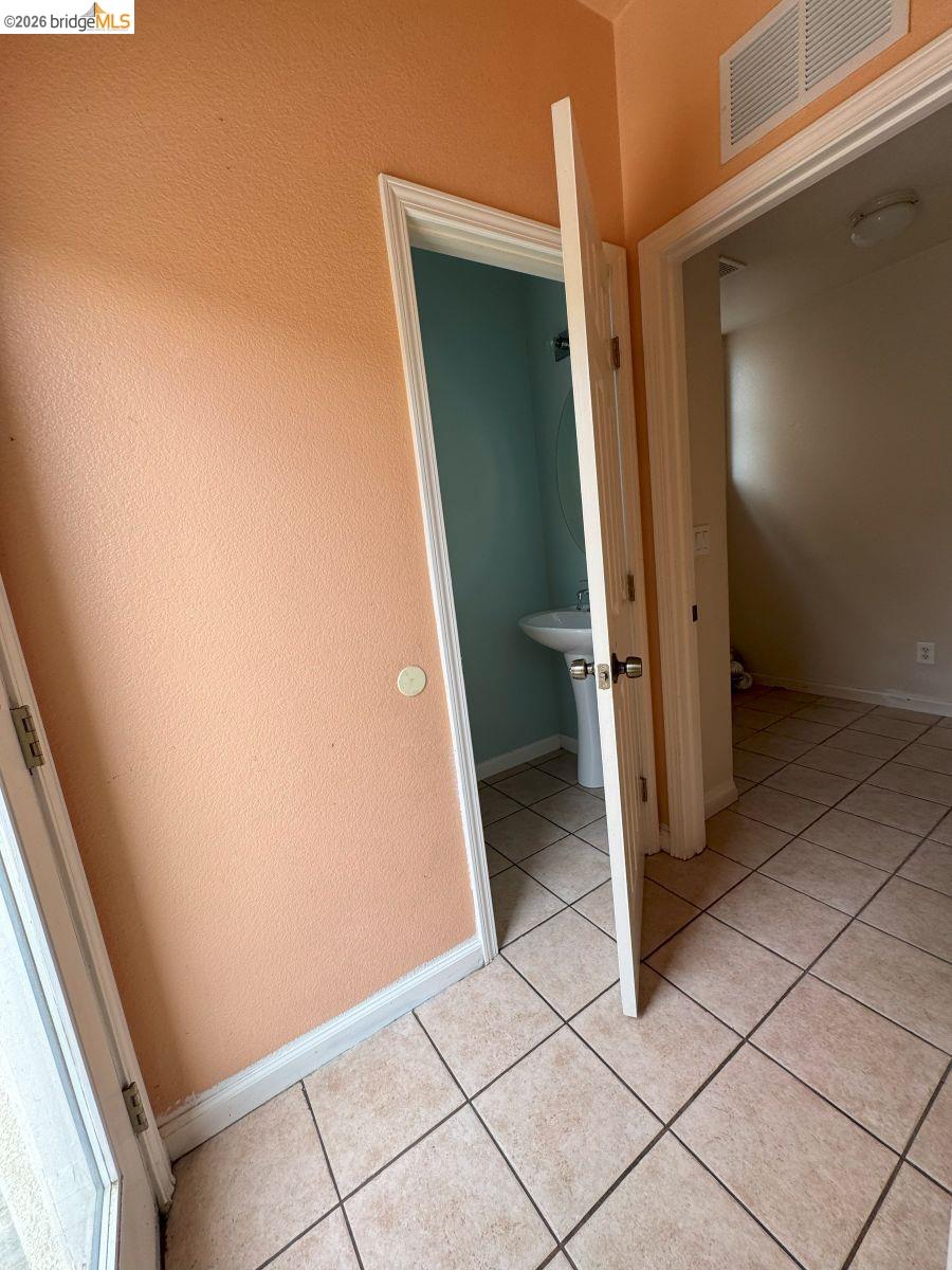 645 Rockspray Circle Pittsburg, CA 94565 - Photo 20 of 31 Hall with light tile patterned floors and a textured wall