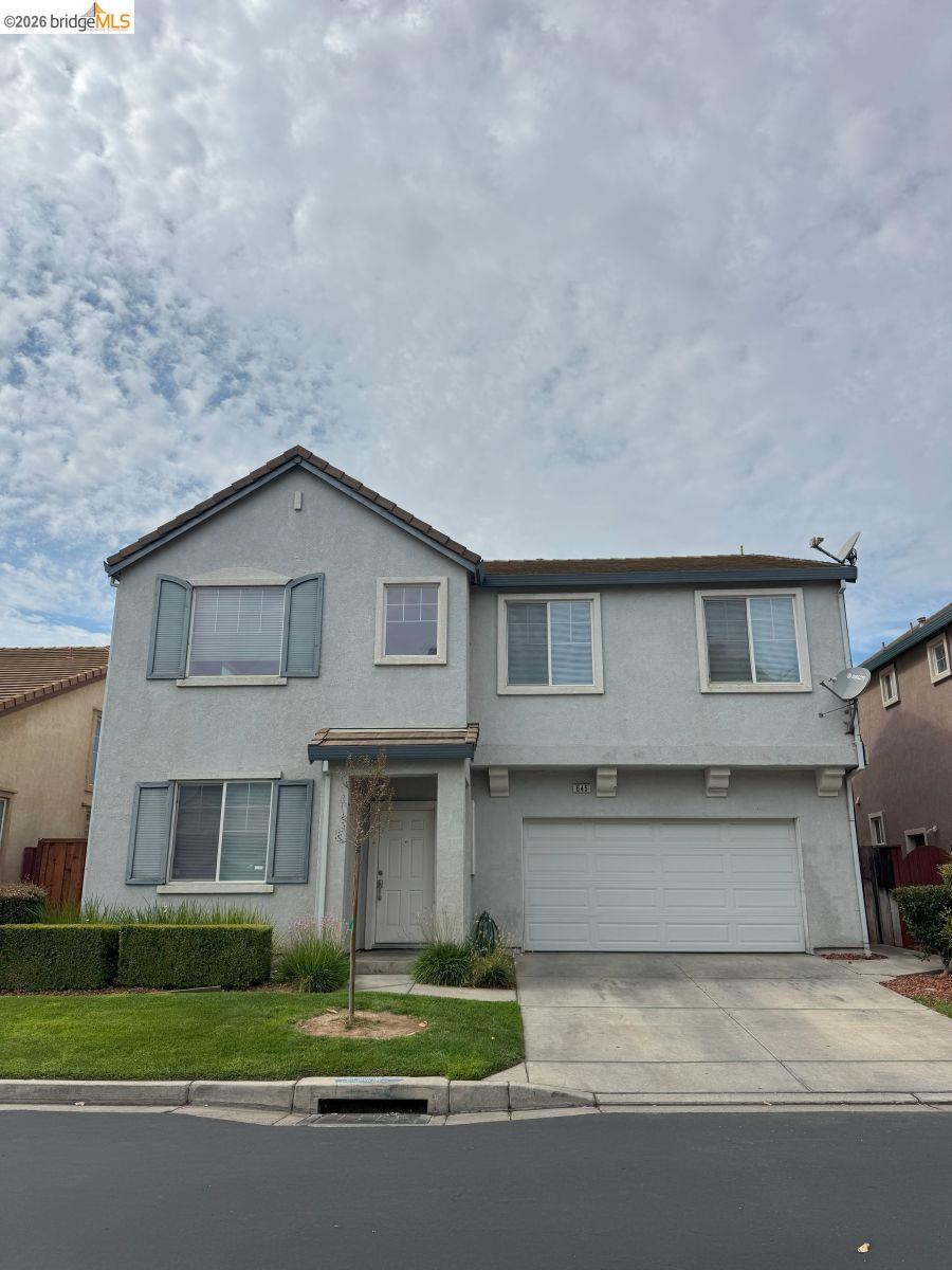 645 Rockspray Circle Pittsburg, CA 94565 - Photo 22 of 31 a front view of a house with a garden and garage