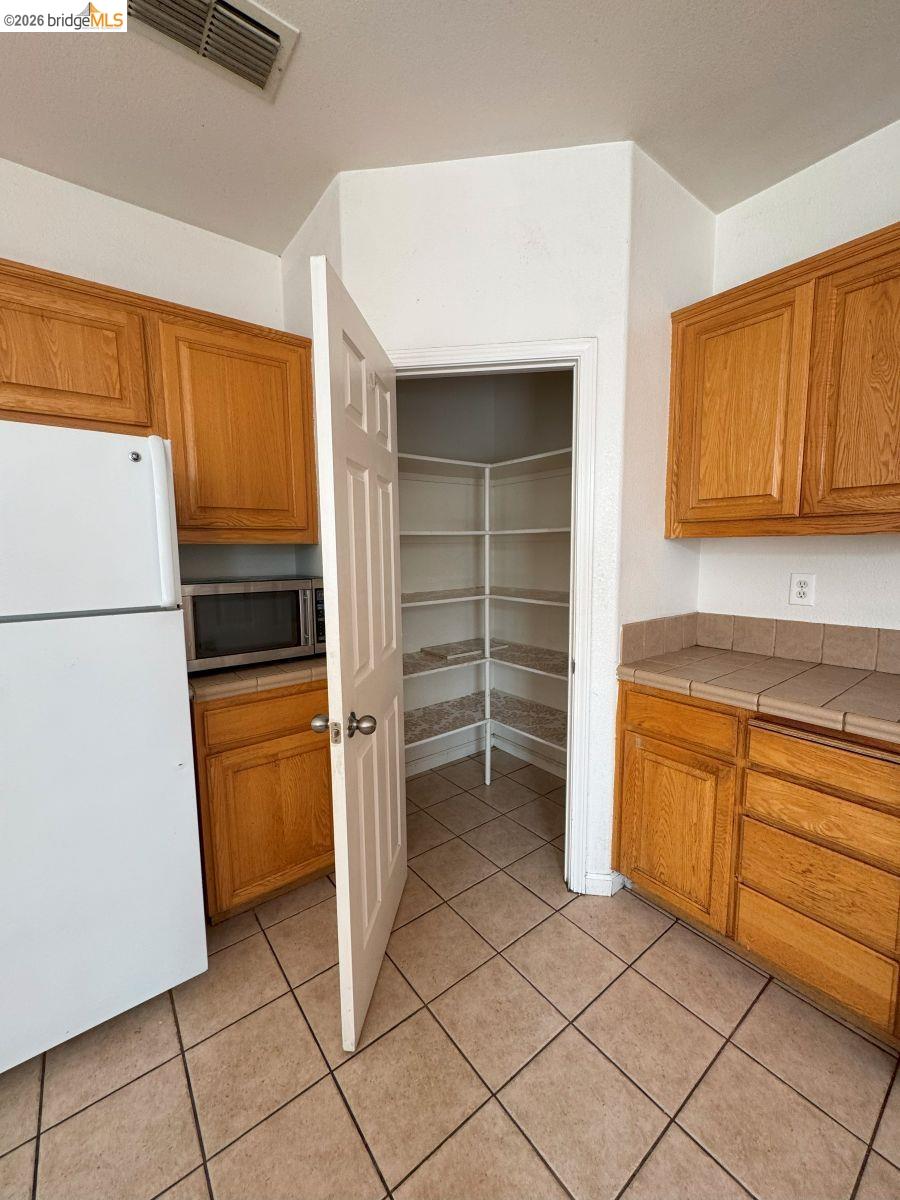 645 Rockspray Circle Pittsburg, CA 94565 - Photo 24 of 31 a kitchen with stainless steel appliances a refrigerator and cabinets