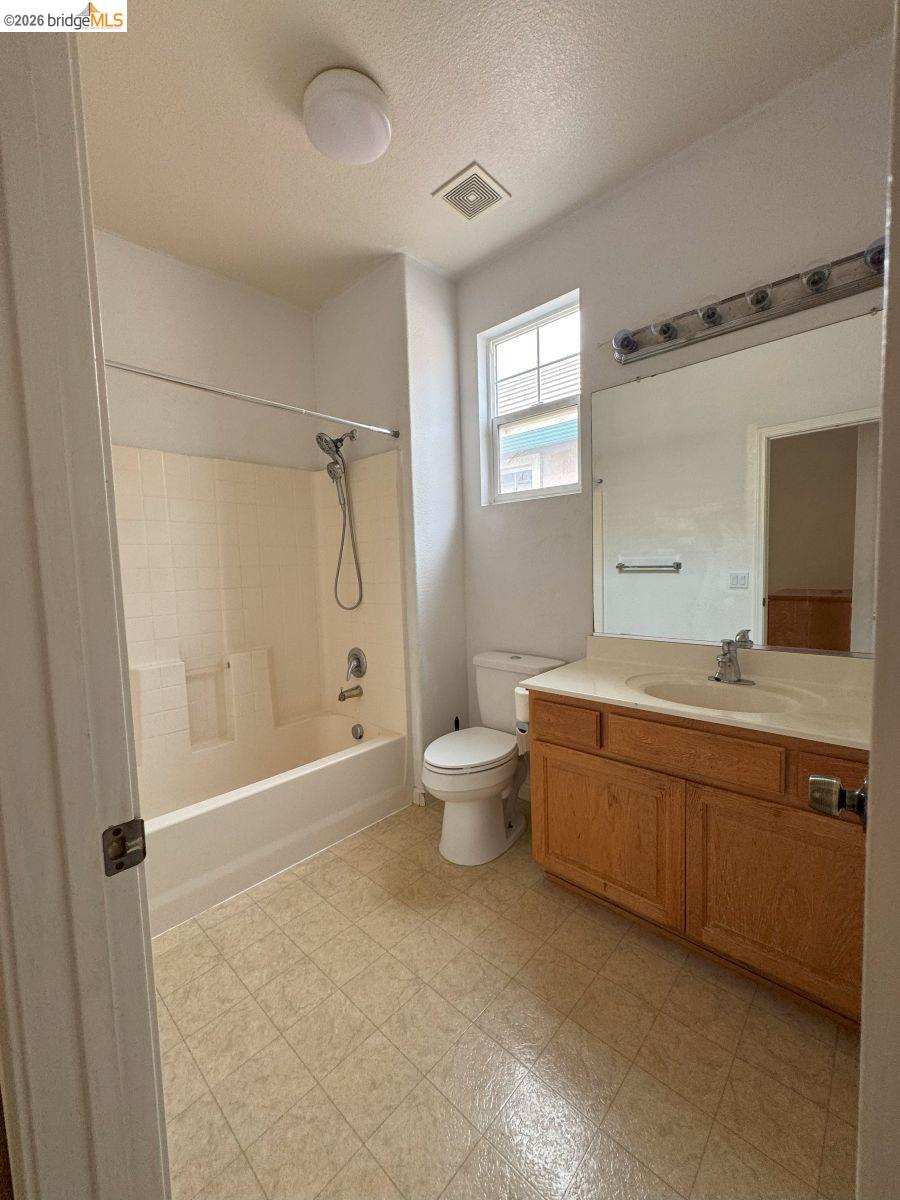 645 Rockspray Circle Pittsburg, CA 94565 - Photo 4 of 31 a bathroom with a granite countertop sink a toilet and shower