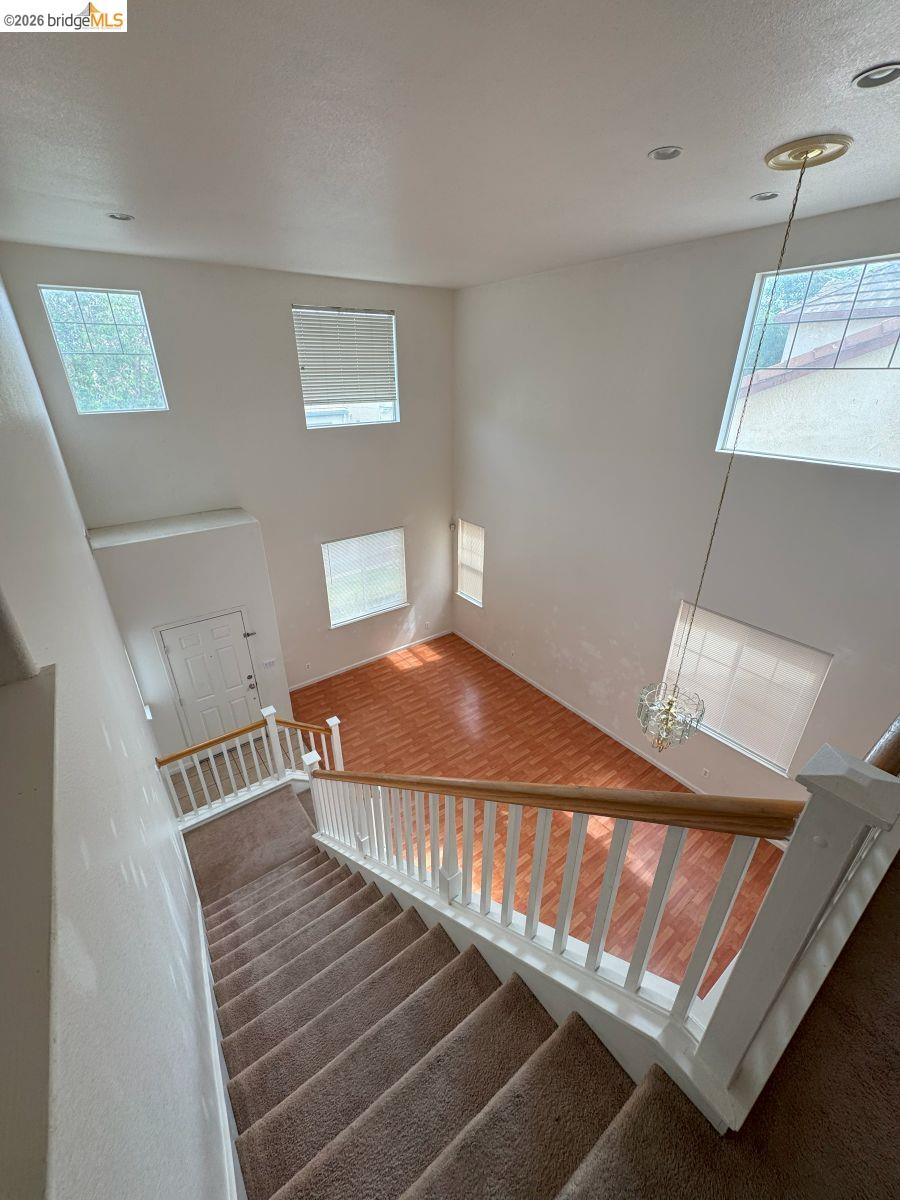 645 Rockspray Circle Pittsburg, CA 94565 - Photo 7 of 31 Staircase with a textured ceiling and a high ceiling