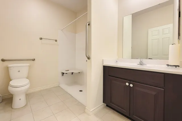 a bathroom with a sink toilet and a mirror