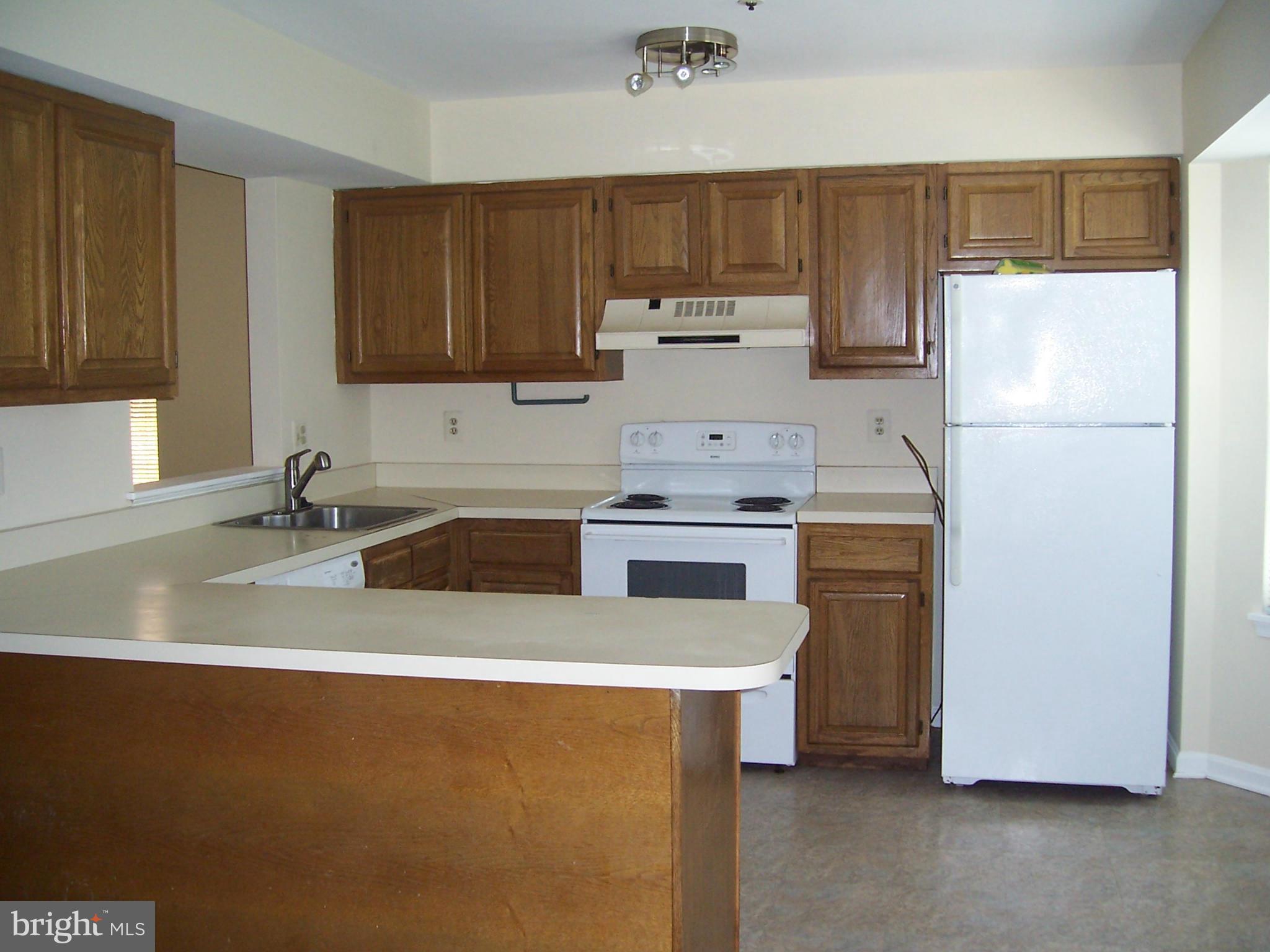 14621 Colonels Choice Road Upper Marlboro, MD 20772 - Photo 2 of 25 a kitchen with a sink a stove a refrigerator and a sink