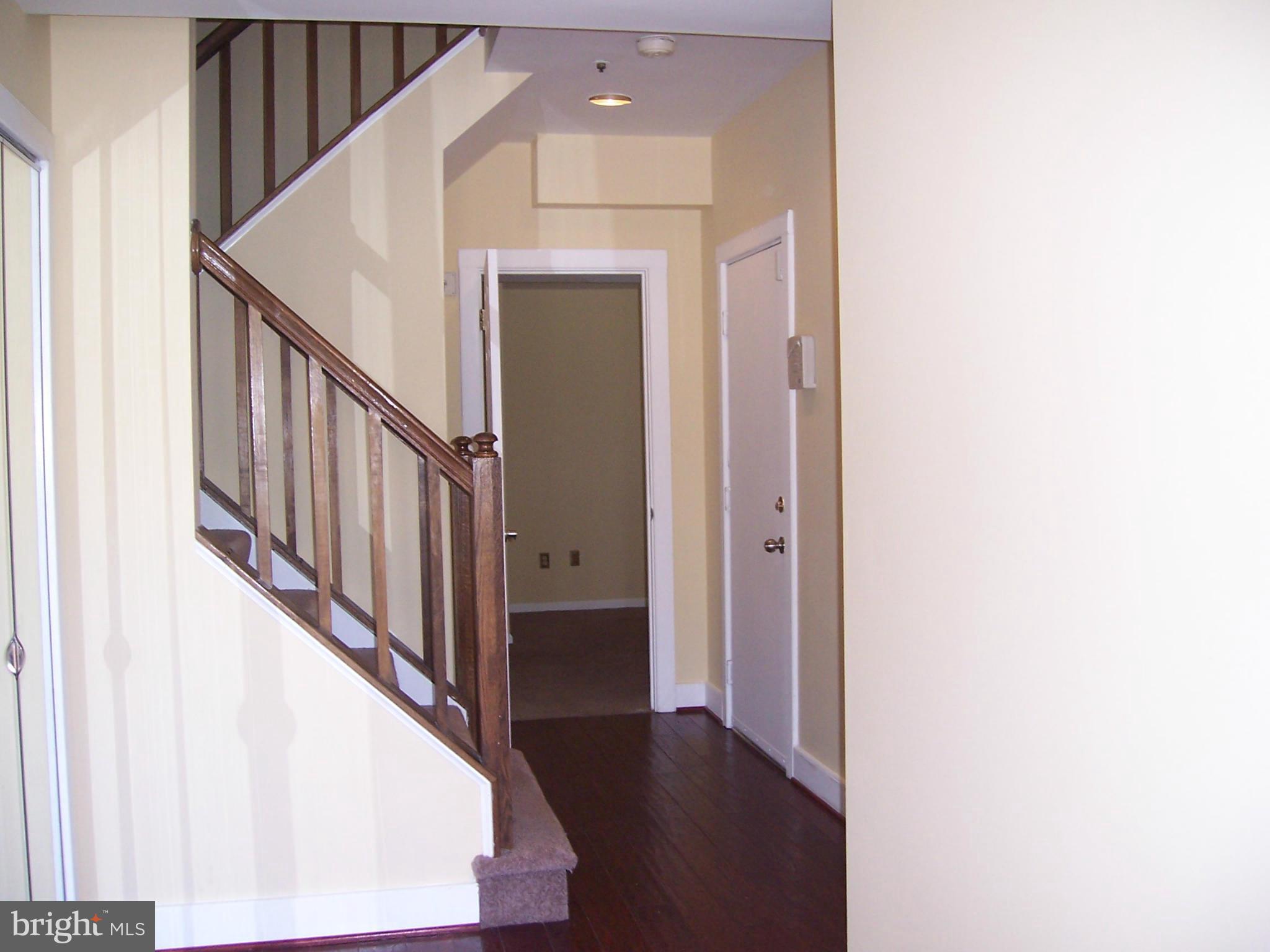 14621 Colonels Choice Road Upper Marlboro, MD 20772 - Photo 3 of 25 a view of a hallway with wooden floor and staircase