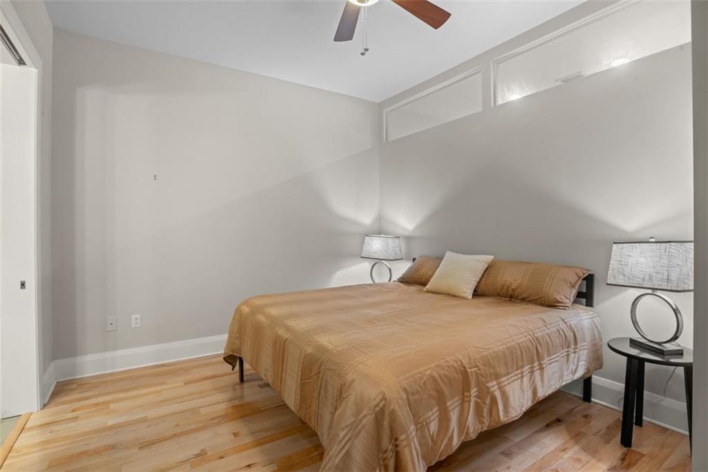 301 Fifth Avenue, Unit 606 Pittsburgh, PA 15222 - Photo 11 of 27 a bedroom with a bed and wooden floor