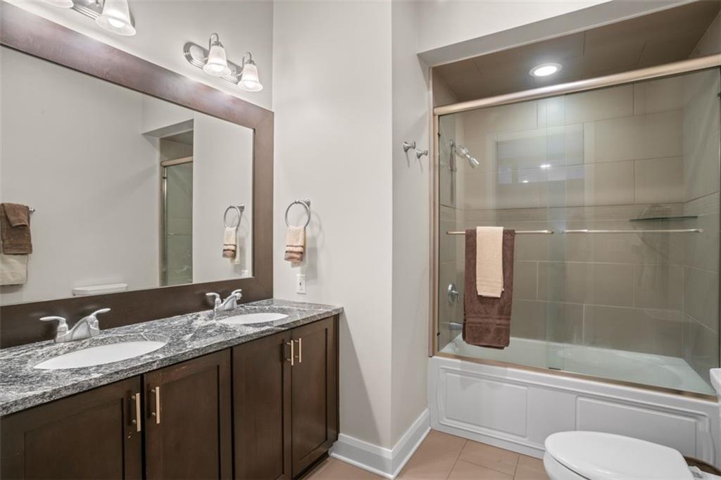 301 Fifth Avenue, Unit 606 Pittsburgh, PA 15222 - Photo 13 of 27 a bathroom with a granite countertop sink toilet and shower