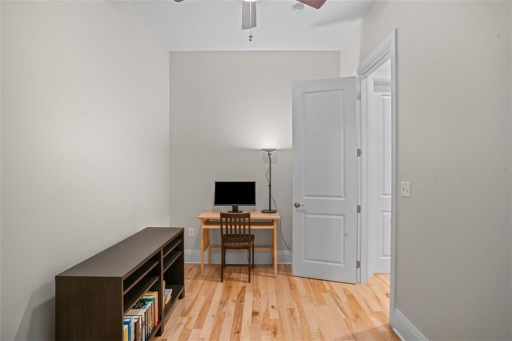 301 Fifth Avenue, Unit 606 Pittsburgh, PA 15222 - Photo 16 of 27 a view of a workspace with furniture and wooden floor