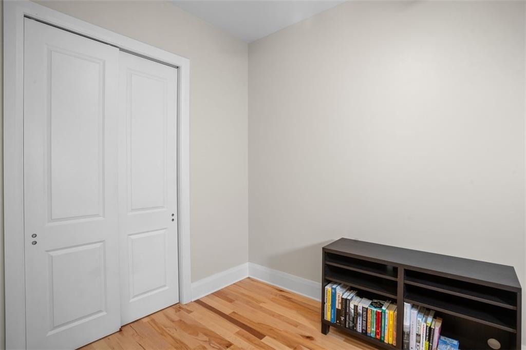 301 Fifth Avenue, Unit 606 Pittsburgh, PA 15222 - Photo 17 of 27 a room with a bed and a book shelf