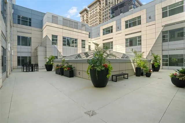a view of a patio with table and chairs and potted plants