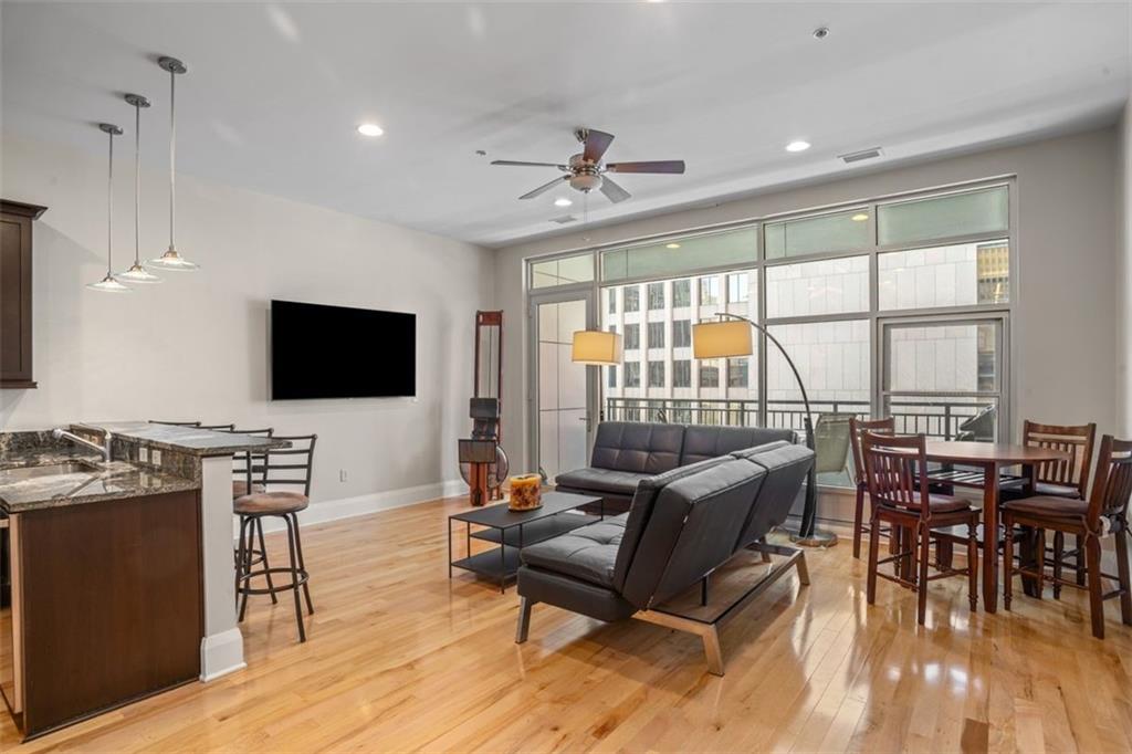 301 Fifth Avenue, Unit 606 Pittsburgh, PA 15222 - Photo 4 of 27 a living room with furniture and a flat screen tv