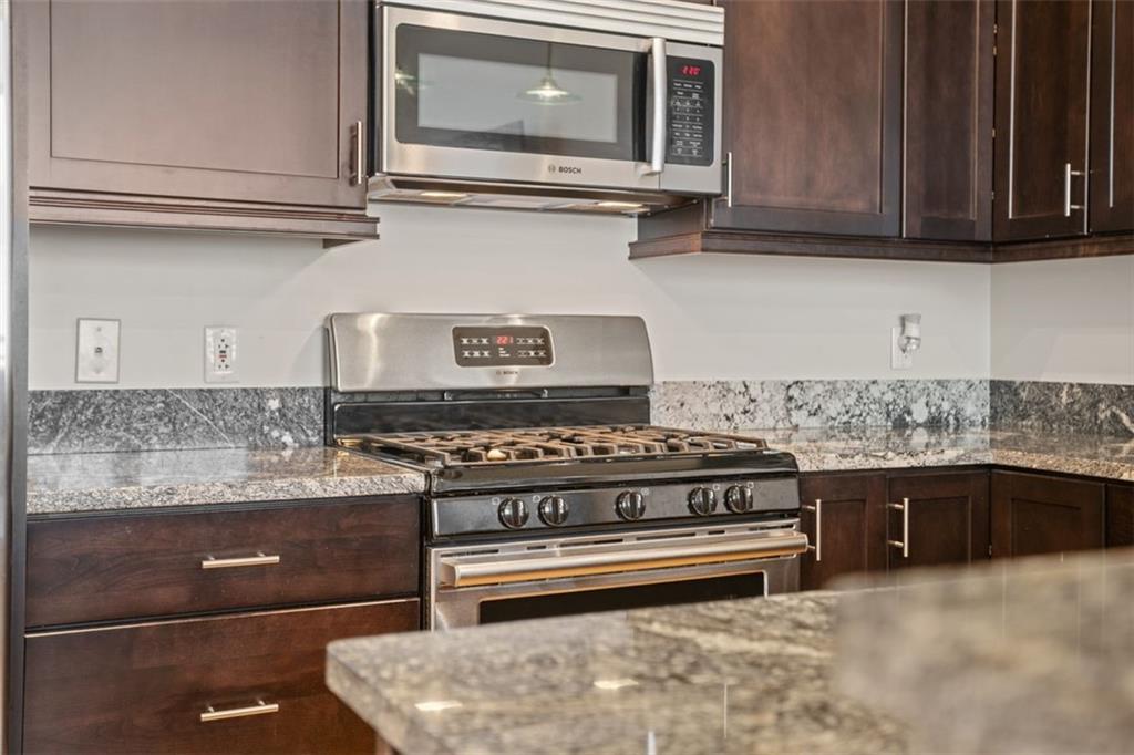 301 Fifth Avenue, Unit 606 Pittsburgh, PA 15222 - Photo 8 of 27 a stove top oven sitting inside of a kitchen