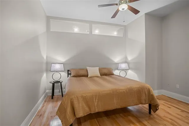 a bedroom with a bed and wooden floor
