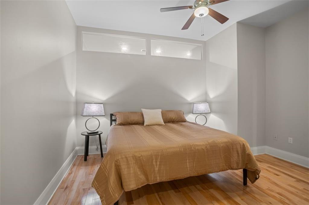 301 Fifth Avenue, Unit 606 Pittsburgh, PA 15222 - Photo 10 of 27 a bedroom with a bed and a chandelier