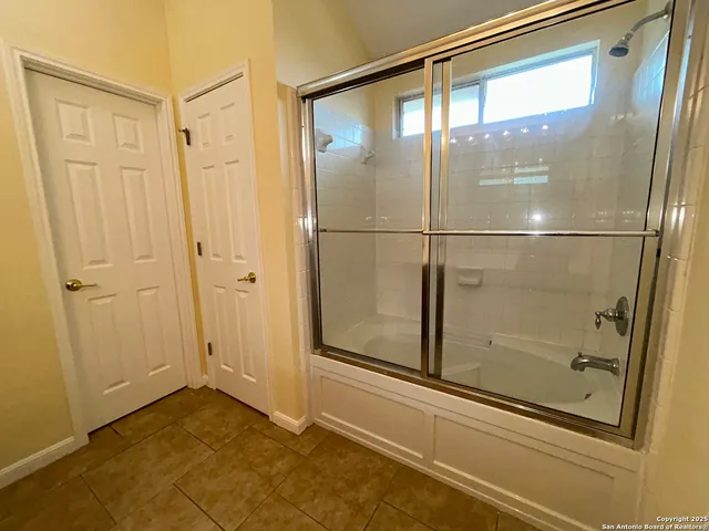 a bathroom with a glass shower door