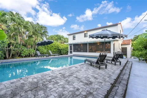 a swimming pool with outdoor seating and yard