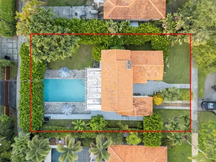 an aerial view of a house with a garden and a yard