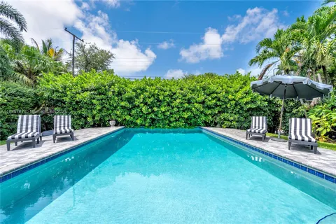 a view of a backyard with sitting area