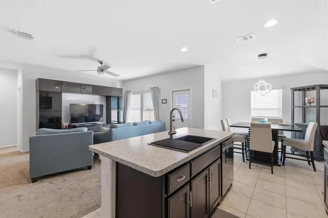a kitchen that has a lot of cabinets a sink and a stove in it