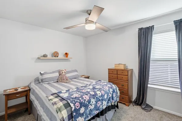 a bedroom with a bed and dresser