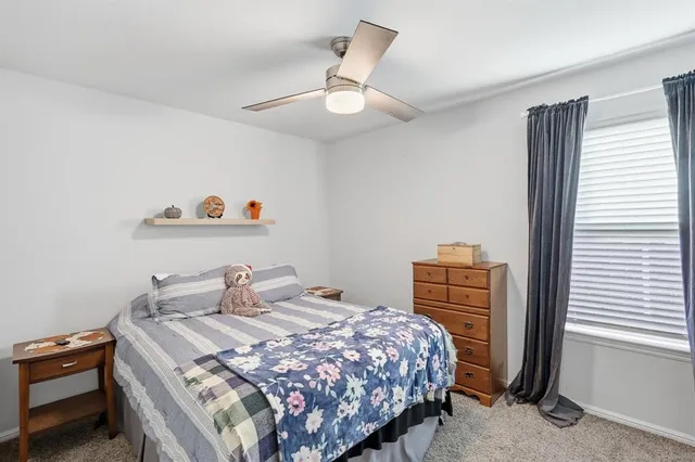 a bedroom with a bed and dresser