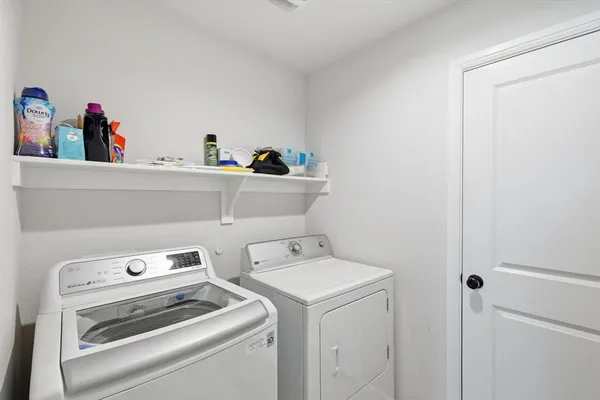 a view of storage and utility room with washer and dryer
