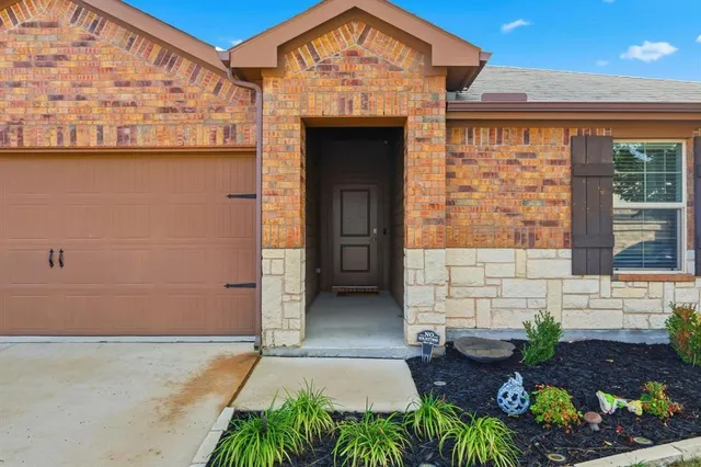 a front view of a house with outdoor seating and plants