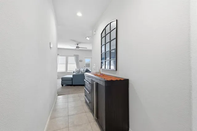 a view of a bedroom with a bed and a window