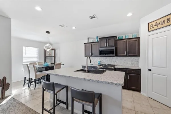 a kitchen with a stove a sink and a refrigerator